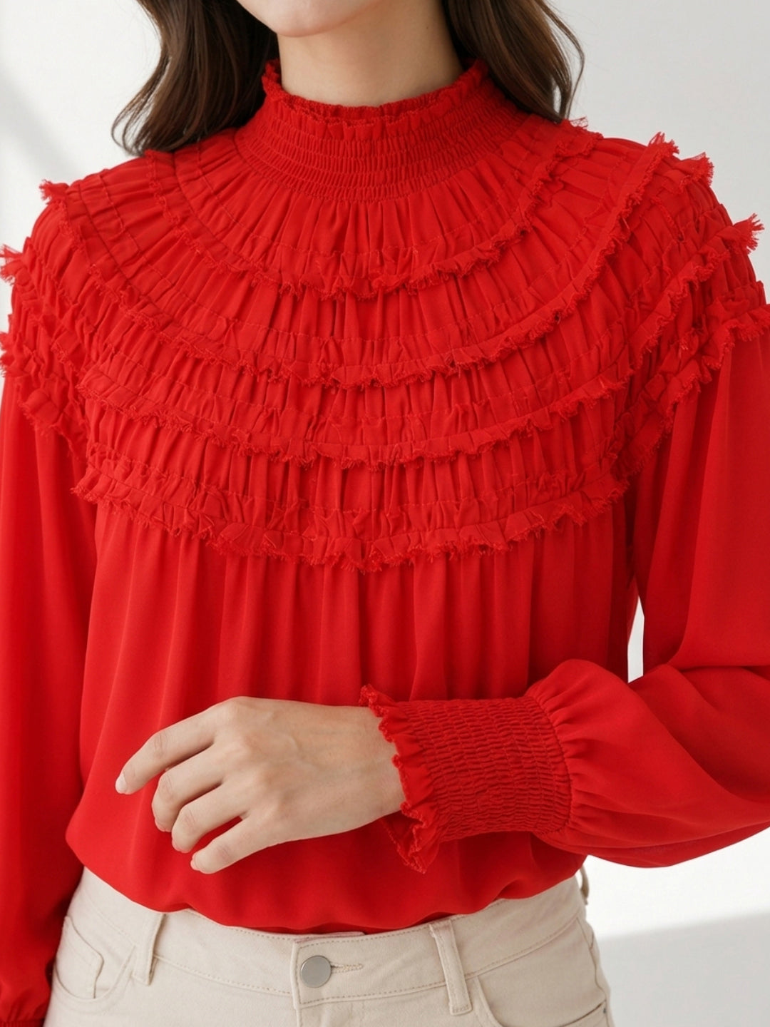Red ruffled high-neck blouse with tiered frills and smocked cuffs, stylish women's fashion top