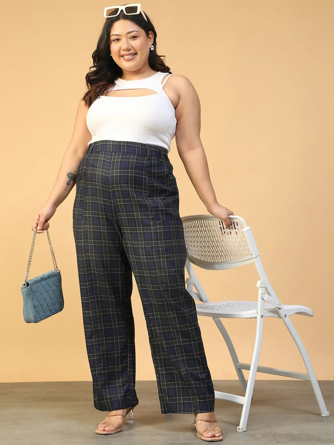 A person wearing a pair of black and green plaid pants.