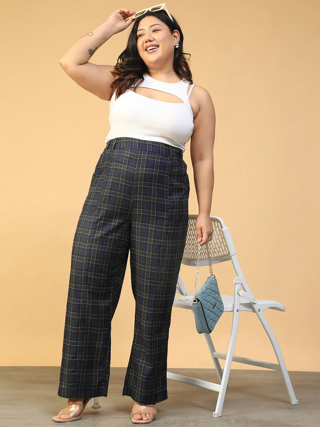 A person wearing a pair of black and green plaid pants.