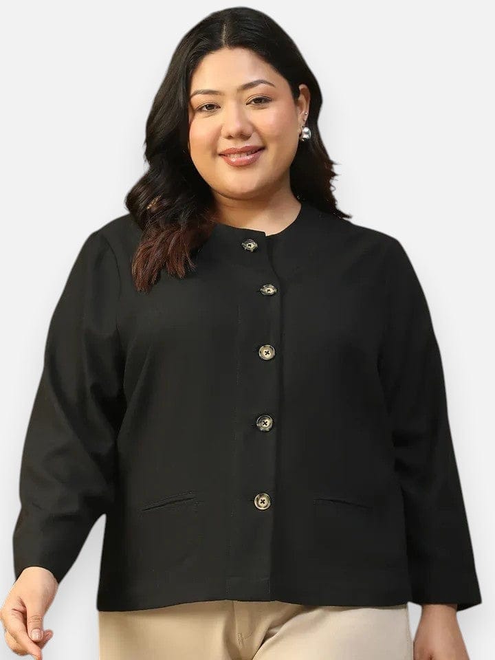 A woman with long dark hair wearing a black jacket with gold buttons, smiling at the camera.